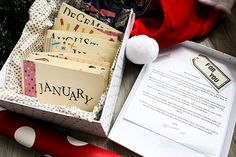 an open box filled with christmas cards next to a santa hat