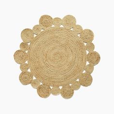 the round rug is made out of jute and has an intricate design on it