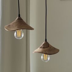 two wooden lamps hanging from the ceiling