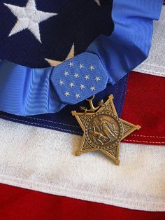 an award is placed on top of the american flag with a star and ribbon around it