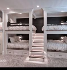 a room with bunk beds and stairs in it