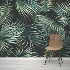 a chair in front of a wallpaper with palm leaves on the side and a black background