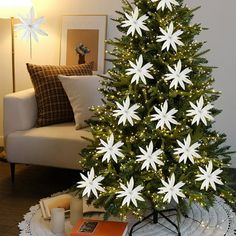 a christmas tree with white snowflakes on it