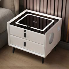 a white and black box sitting on top of a wooden floor