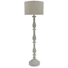 a white floor lamp with a beige shade