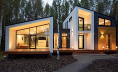 two modern houses in the woods at night