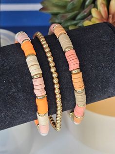 two bracelets are sitting on top of each other