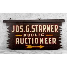 a wooden sign that says jos g stanner public auctioneer on it