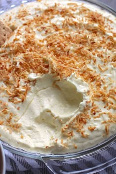 there is a pie with white frosting and toasted coconut on top