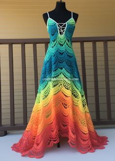 a crocheted dress is displayed on a mannequin