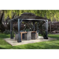 a gazebo sitting on top of a lush green field