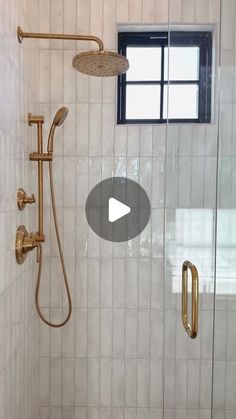 a walk in shower next to a window and tiled wall with white tiles on it