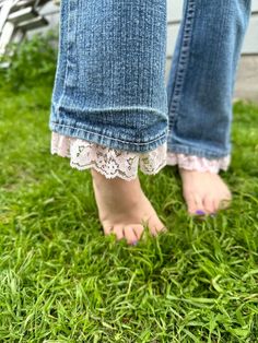 a person standing in the grass with their feet up