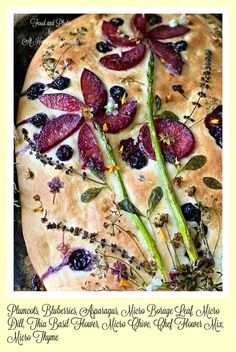 a pizza with asparagus and dried berries on it