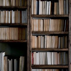 an old wooden bookcase filled with lots of books