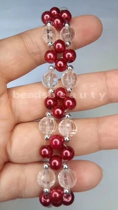 the beaded bracelet is made with red pearls and clear glass beads, which are attached to