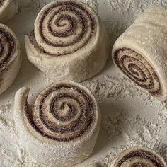 several cinnamon rolls sitting on top of a white table