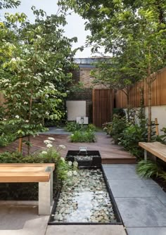 an outdoor garden with water feature and benches