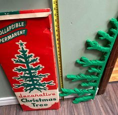 an old fashioned christmas tree is next to a cardboard box that has been cut out