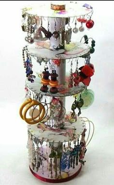 there is a tower that has many items on it, including rings and necklaces