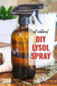 an image of a diy lysol spray bottle on a table with rosemary