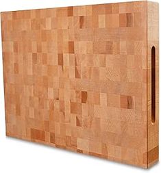 a large wooden cutting board with holes in the center and bottom part cut off from it