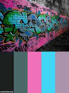 a brick wall with colorful graffiti on it and the colors are black, pink, blue, green, and purple