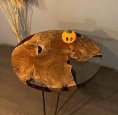 a wooden table with an orange pumpkin on top