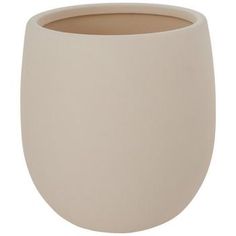 a white vase sitting on top of a table