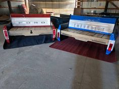 two wooden benches sitting next to each other on top of a rug in a building