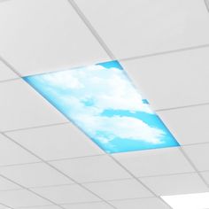 an empty room with white walls and blue sky painted on the ceiling