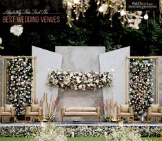 an outdoor ceremony setup with white flowers and greenery on the wall, couches and chairs