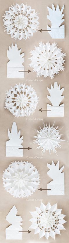 paper cut snowflakes are arranged on a sheet of white paper with arrows pointing to them