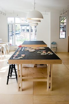 a kitchen with an island table and stools in front of the counter top that is made out of wood