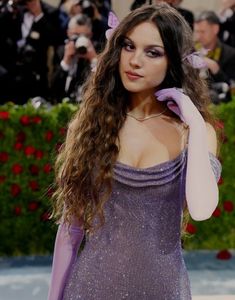 a woman with long hair and purple dress