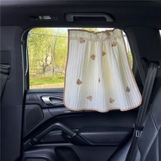 the back seat of a car with a curtain hanging from it's side window