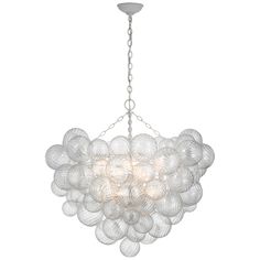 a chandelier with white glass balls hanging from it's center point, on a metal chain