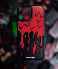 a red and black phone case sitting on top of a table