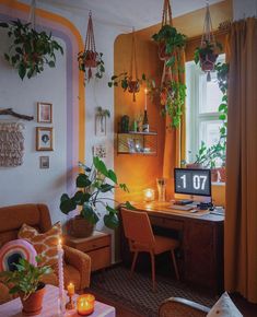 a living room filled with furniture and lots of plants on the windowsill, next to a window sill