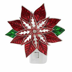 a red and white christmas poinsettia light switch cover with green leaves on it