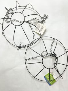 two circular metal objects with chains attached to them