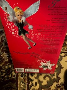 the back of a box with a tinkerbell doll on it's side