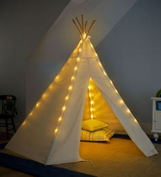 a teepee with some lights on it in a room