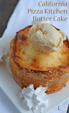 a pastry with ice cream on top is sitting on a white plate next to some whipped cream