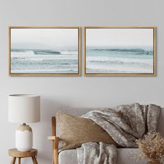 two framed pictures hang on the wall above a couch