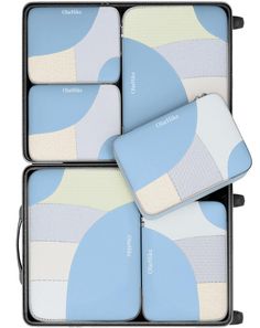 four pieces of blue and white luggage sitting in a box on top of each other