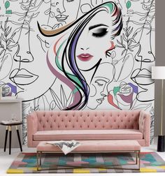 a living room with a pink couch and wall mural