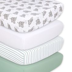 three mattresses stacked on top of each other in different colors and patterns, one with an elephant print