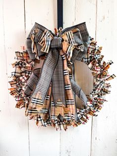 a plaid wreath hanging on the side of a door