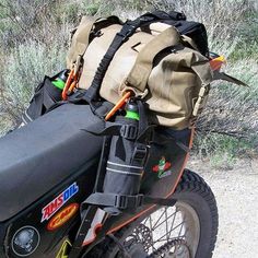 the back end of a motorcycle with bags on it